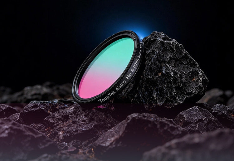 Telescope filter with gradient colors on a dark rock surface