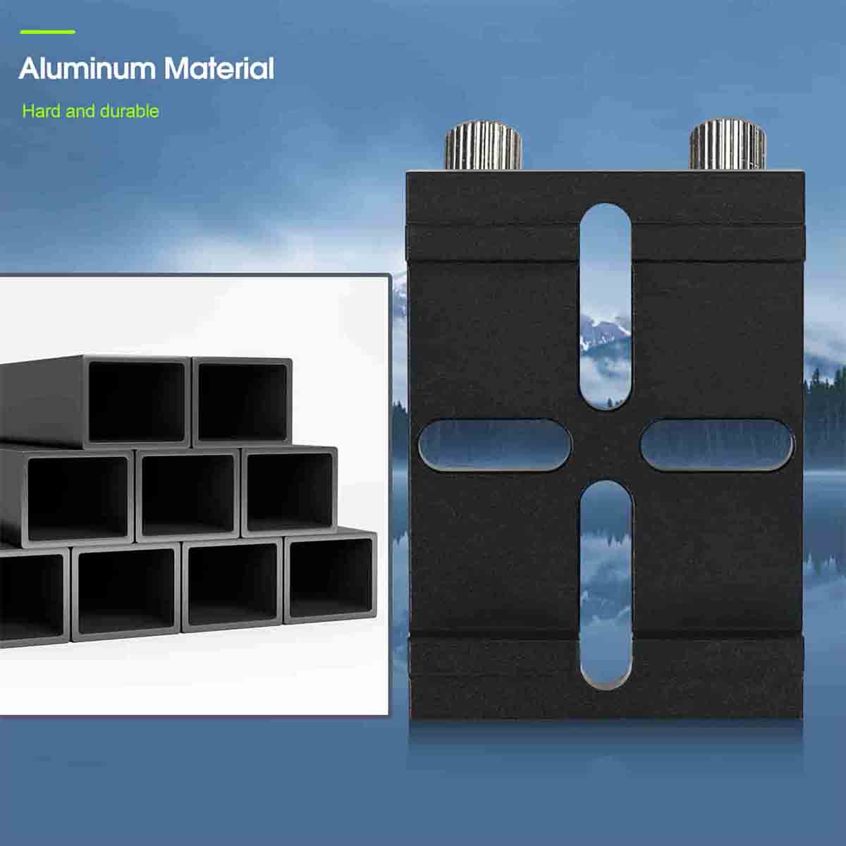 Black metal block with cylindrical ends on a reflective surface, with mountains in the background.