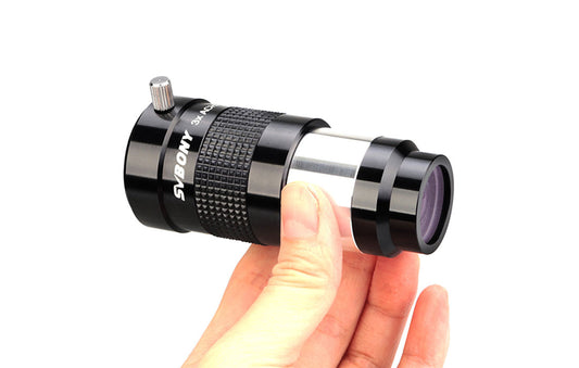 Hand holding a Svbony SV136 Barlow 3x 1.25 inch on a white background