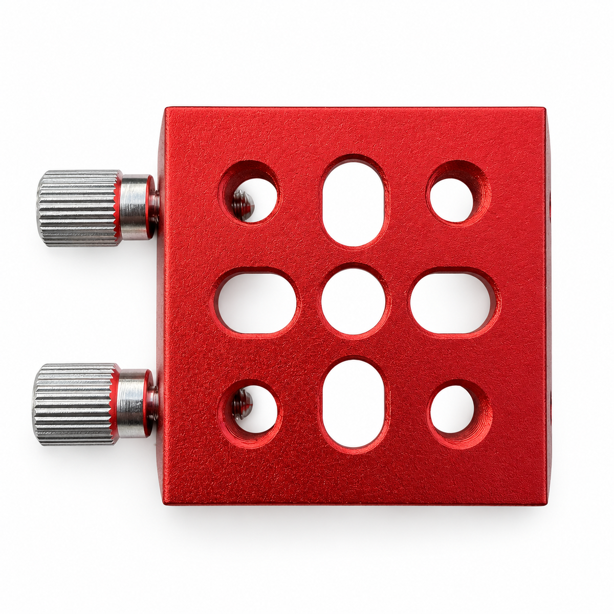 Underside of the red AIR-DOCK clamping base showing its mounting holes and slots