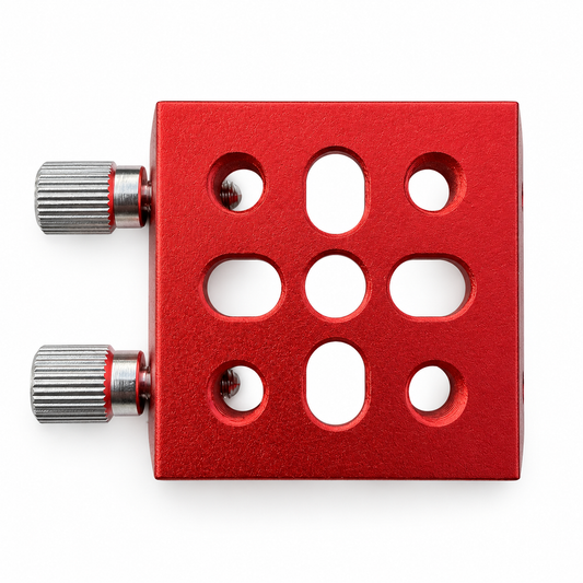 Underside of the red AIR-DOCK clamping base showing its mounting holes and slots