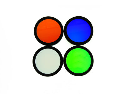 Four Chroma 36mm coloured filters (red, blue, green, white) on a white background