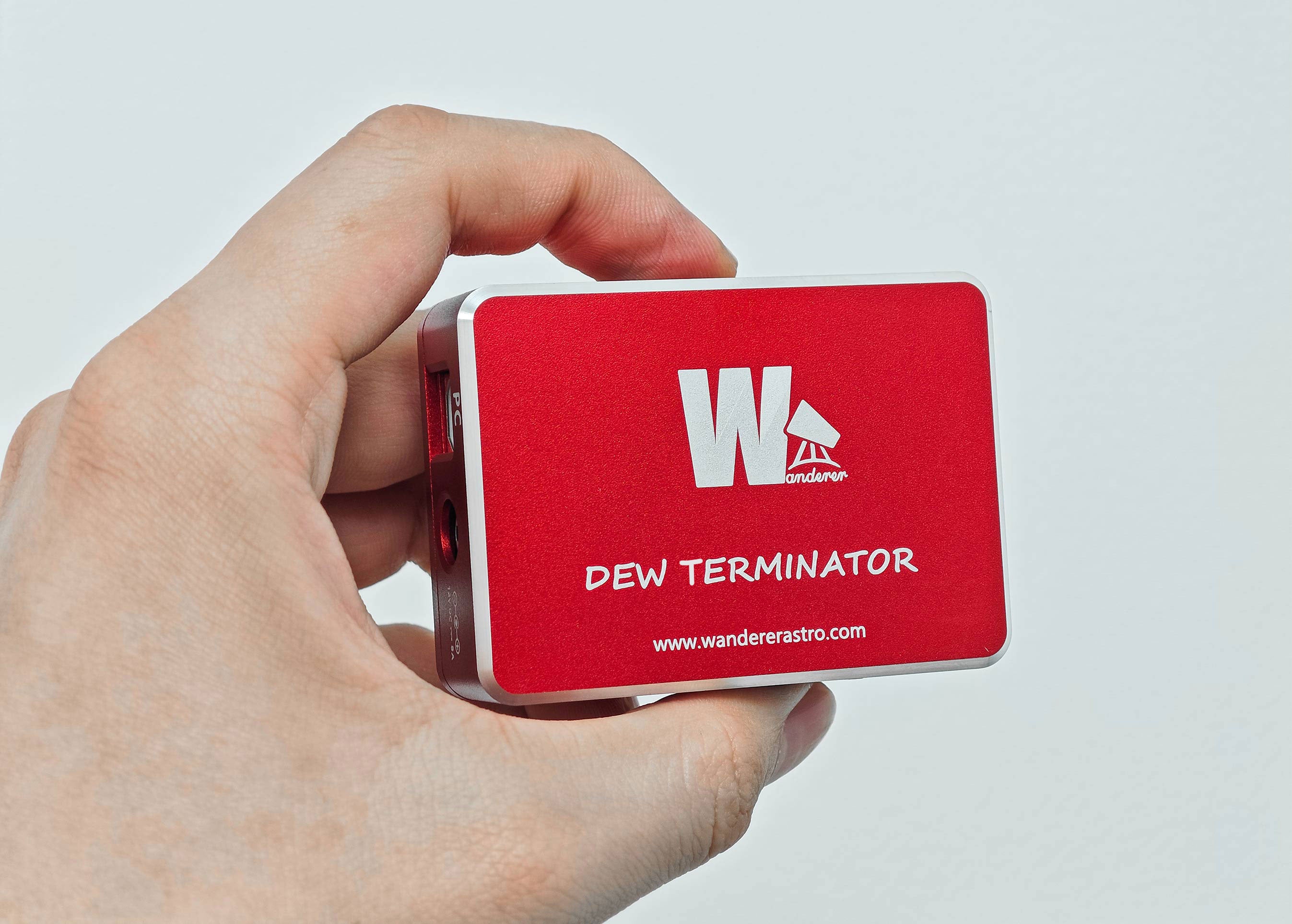 Hand holding the WandererAstro Dew Terminator dew heater controller showing top branding and logo
